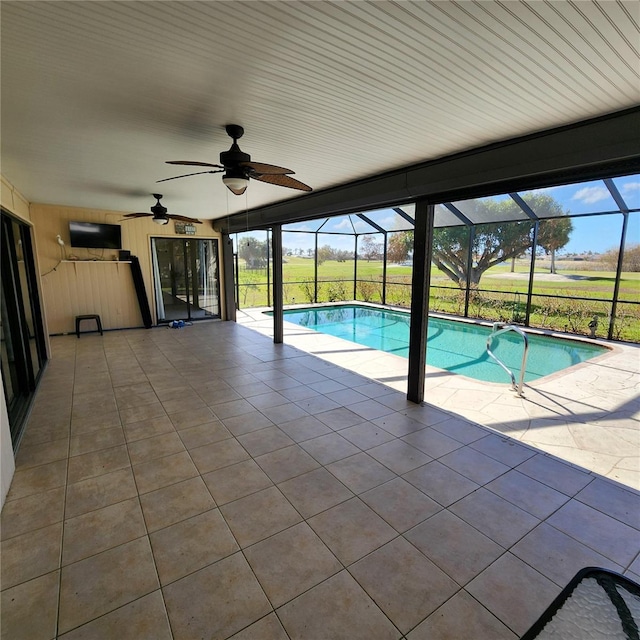 view of swimming pool with a patio, ceiling fan, and glass enclosure