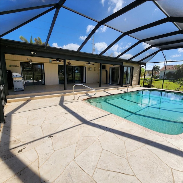 view of pool with a patio, ceiling fan, and a lanai