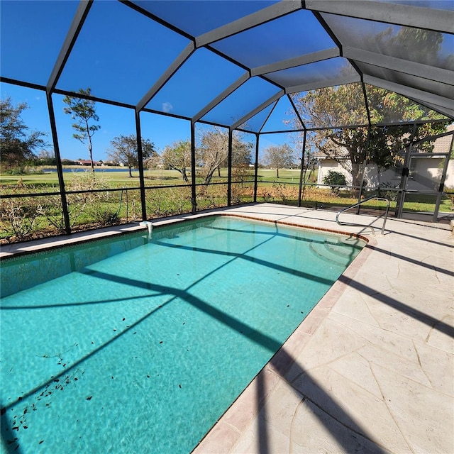 view of swimming pool featuring a patio and glass enclosure