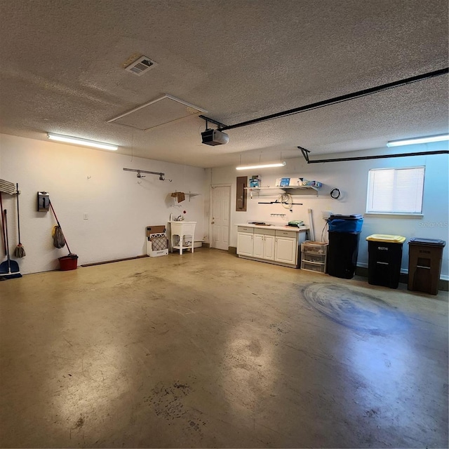 garage with a garage door opener and electric panel