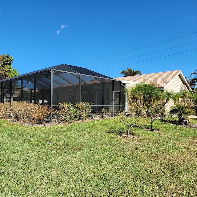 view of yard with glass enclosure