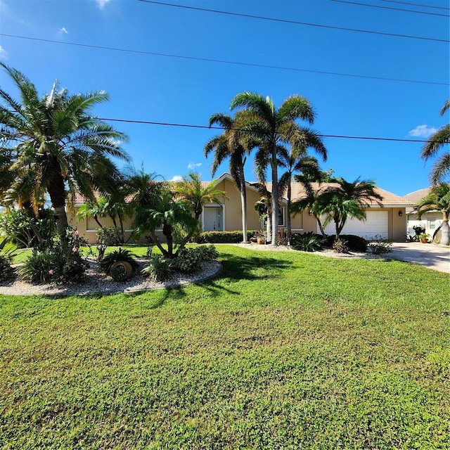 view of front of house with a front lawn, concrete driveway, a garage, and stucco siding