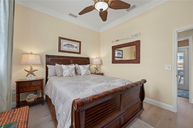 bedroom featuring ceiling fan, light wood-type flooring, and crown molding