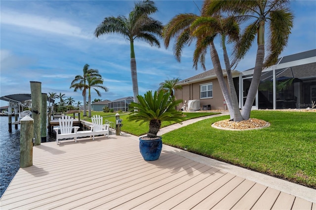 wooden deck featuring a water view, a boat dock, a yard, and glass enclosure