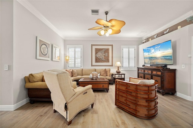 living room with plenty of natural light, ornamental molding, and light hardwood / wood-style flooring