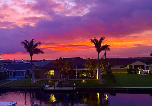 exterior space featuring a water view and a yard