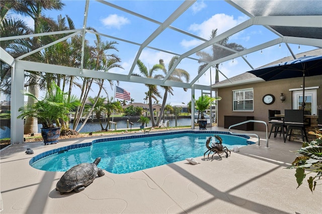 view of swimming pool featuring a patio area, glass enclosure, and a water view