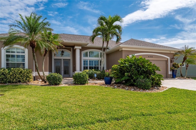 single story home with a front yard and a garage