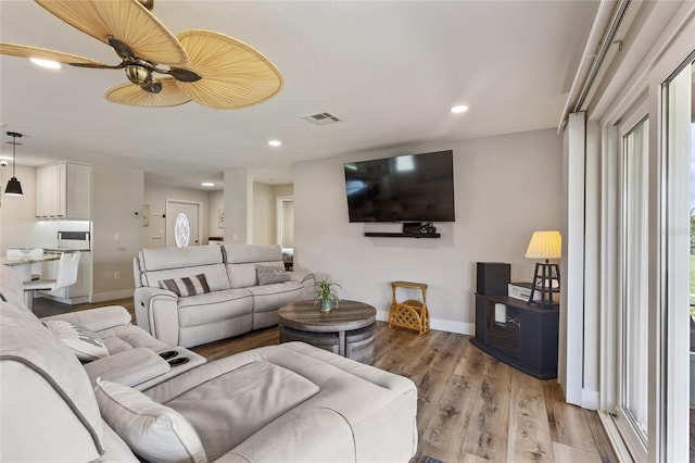 living room featuring ceiling fan and light wood-type flooring