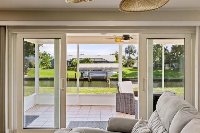 entryway with tile patterned flooring, a water view, and a healthy amount of sunlight