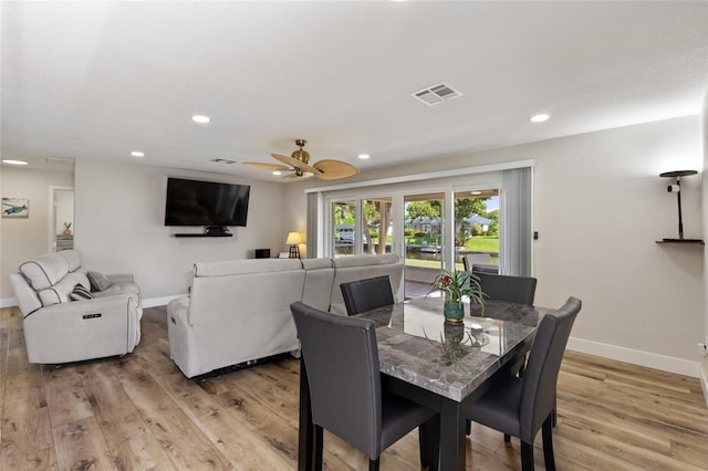 dining area with ceiling fan and light hardwood / wood-style flooring