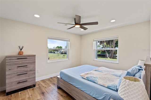 bedroom with light hardwood / wood-style flooring and ceiling fan