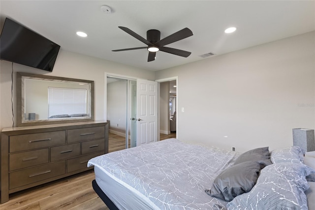 bedroom featuring light wood-type flooring, ceiling fan, and a closet