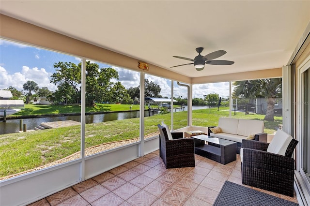 sunroom featuring a water view and ceiling fan