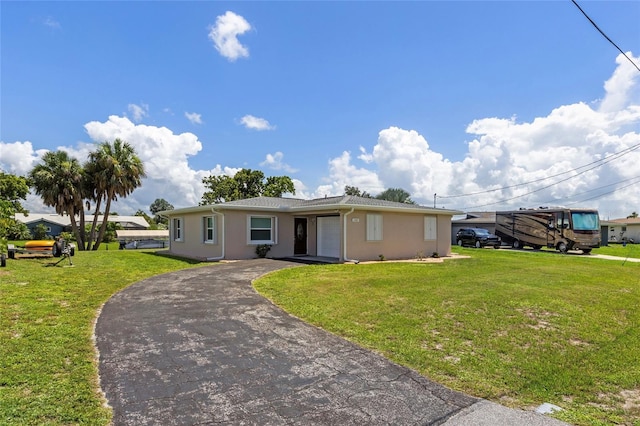 single story home with a garage and a front yard