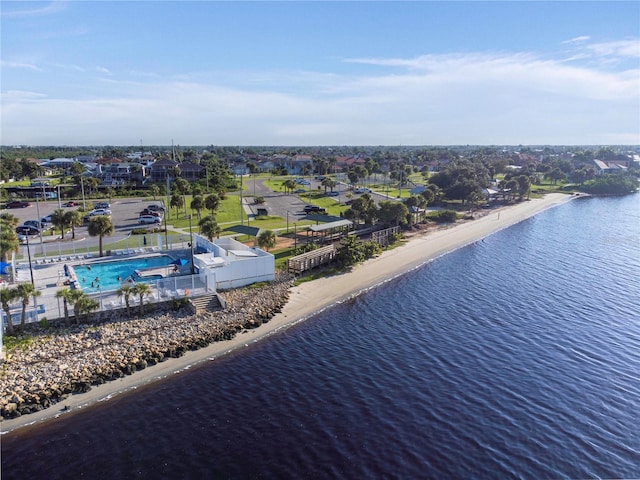 drone / aerial view featuring a beach view and a water view