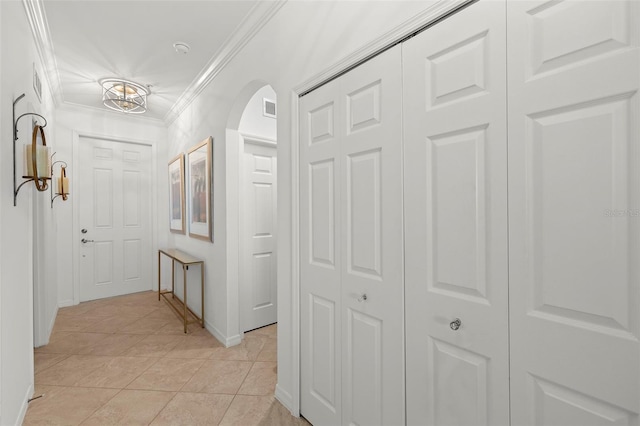 hallway featuring crown molding and light tile patterned floors