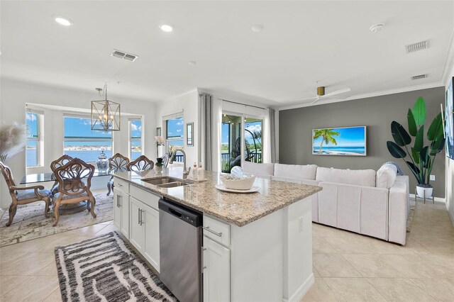 kitchen featuring sink, white cabinetry, a wealth of natural light, stainless steel dishwasher, and a water view