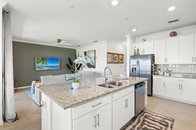 kitchen with sink, a kitchen island with sink, stainless steel appliances, and white cabinetry