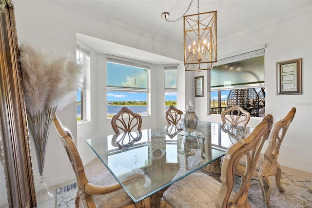 dining area with ornamental molding and a chandelier