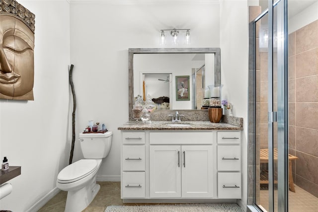 bathroom featuring vanity, toilet, tile patterned floors, and an enclosed shower