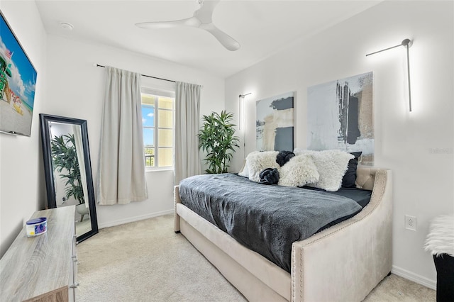 bedroom with ceiling fan and light carpet