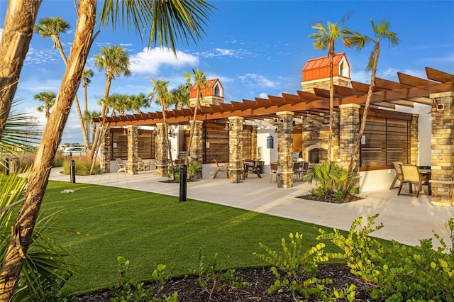 view of home's community with a pergola, a patio, and a yard