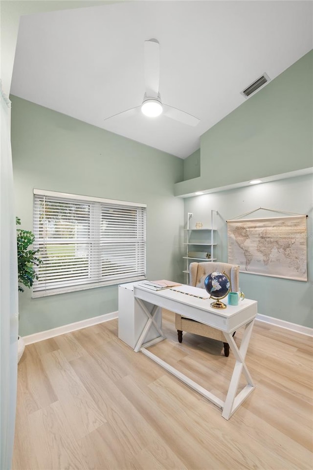 home office featuring ceiling fan, light hardwood / wood-style flooring, and lofted ceiling