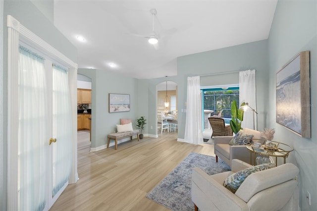 living area featuring light wood-type flooring and ceiling fan