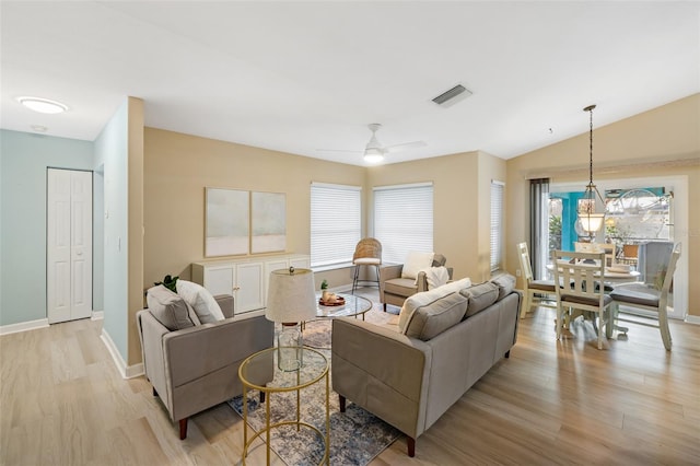 living room featuring a wealth of natural light, ceiling fan, light hardwood / wood-style floors, and lofted ceiling