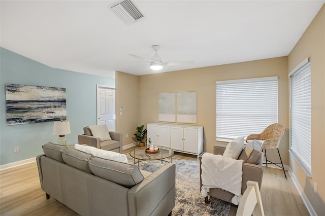 living room featuring ceiling fan and light hardwood / wood-style floors