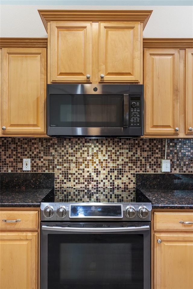 kitchen featuring decorative backsplash, light brown cabinetry, stainless steel appliances, and dark stone counters