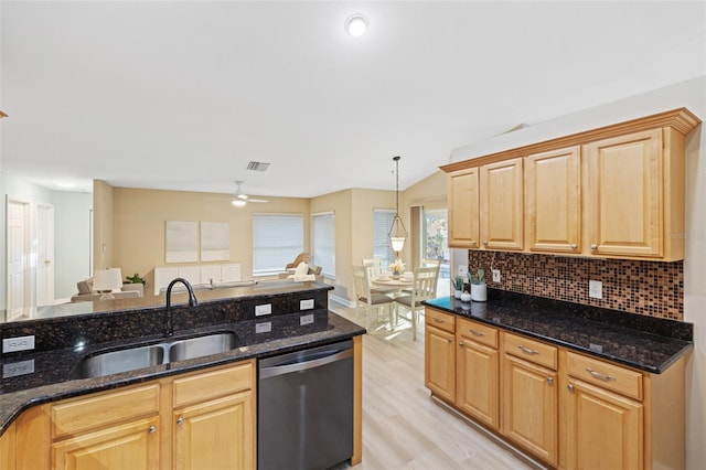 kitchen with dishwasher, decorative light fixtures, dark stone counters, and sink