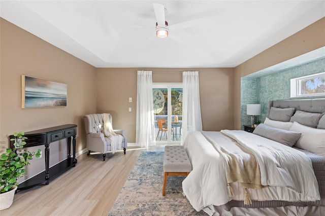 bedroom with access to outside, light hardwood / wood-style flooring, and ceiling fan