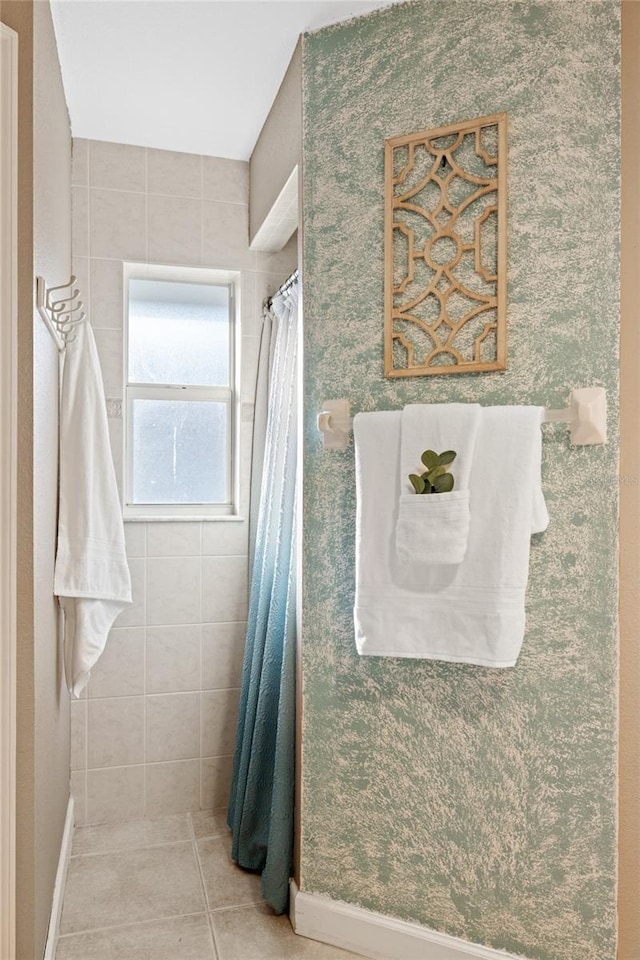 bathroom with tile patterned flooring and a shower with shower curtain