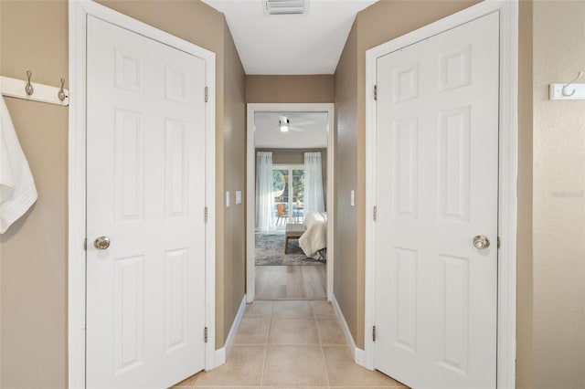 corridor featuring light tile patterned flooring