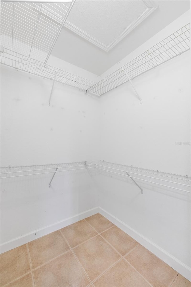 walk in closet featuring tile patterned flooring