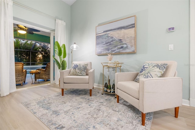 living area featuring ceiling fan and hardwood / wood-style flooring