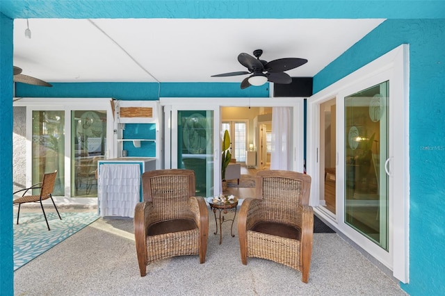 sunroom / solarium featuring ceiling fan