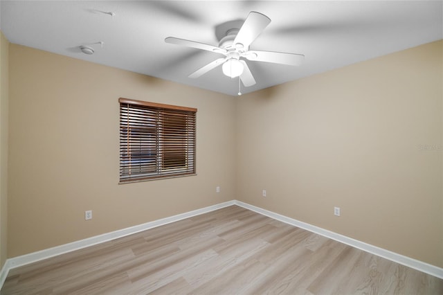 spare room featuring ceiling fan and light hardwood / wood-style flooring