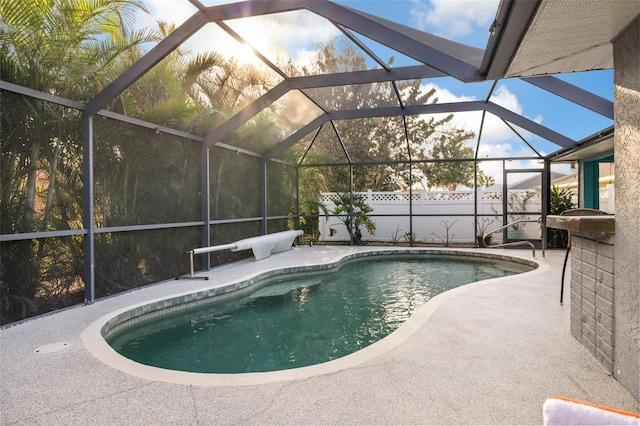 view of pool featuring a patio area and glass enclosure