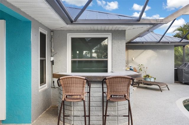 view of patio / terrace with a lanai and grilling area