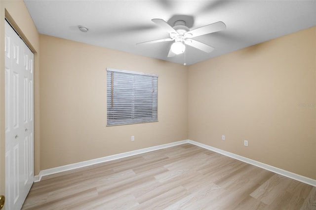 unfurnished bedroom with ceiling fan, light hardwood / wood-style flooring, and a closet