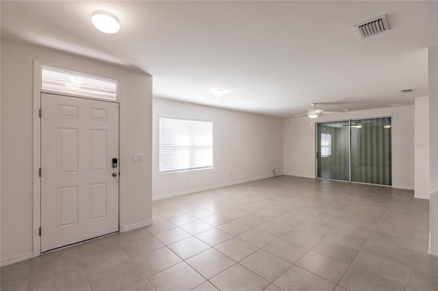 foyer with ceiling fan and light tile patterned floors