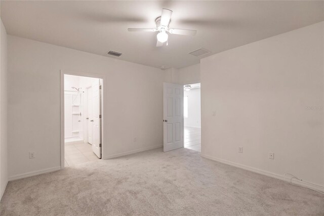 unfurnished room featuring light carpet and ceiling fan