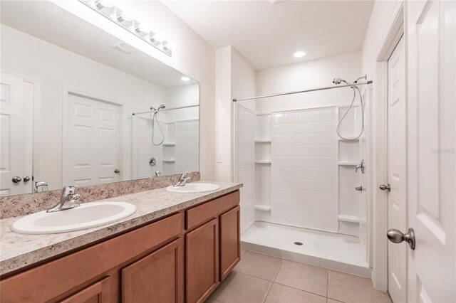 bathroom featuring vanity, tile patterned flooring, and walk in shower