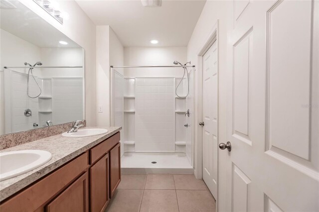 bathroom featuring vanity, tile patterned floors, and walk in shower