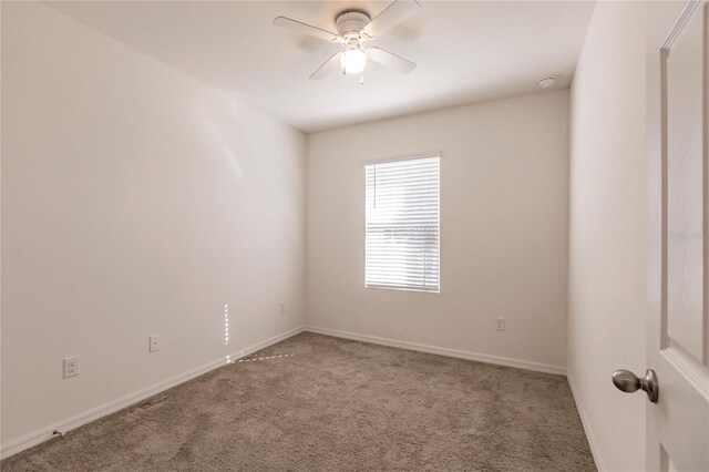 unfurnished room with ceiling fan and carpet