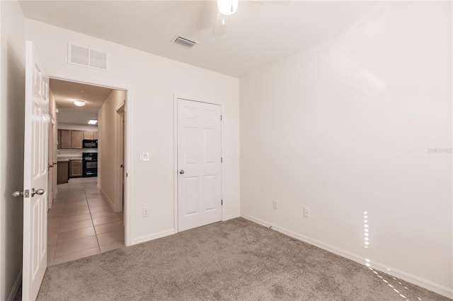 unfurnished bedroom featuring light carpet and ceiling fan