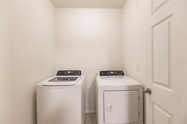 clothes washing area featuring independent washer and dryer